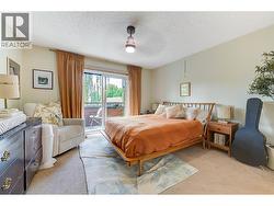 Primary Bedroom, with new lighting and sliding doors to private patio. -