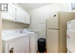 Larger Laundry room with shelving. -