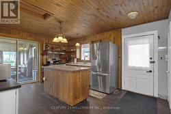 Kitchen with centre island and access to side yard -