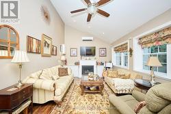 Family room with gas fireplace & vaulted ceiling -