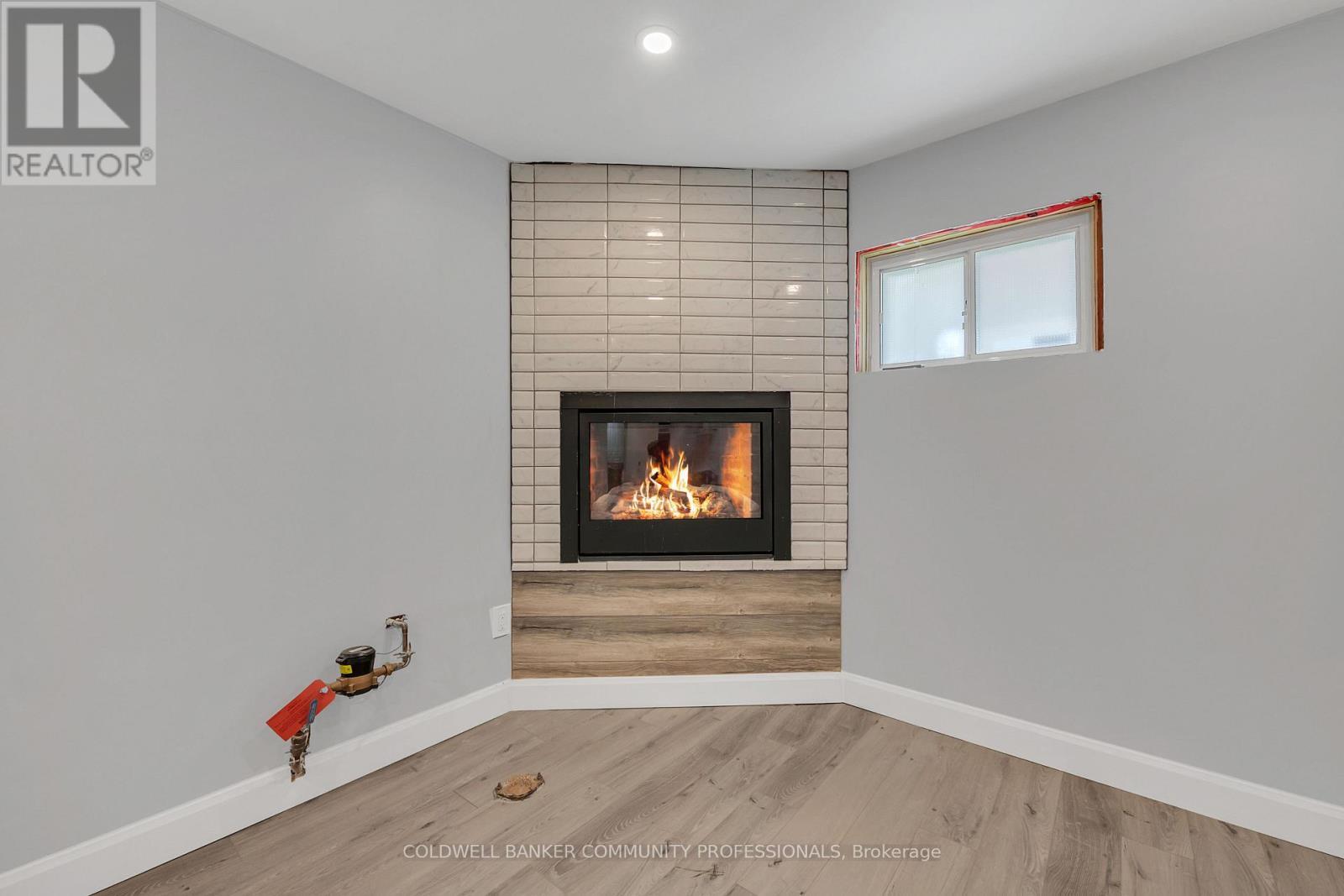 rec room with gas fireplace - 446 East 36Th Street, Hamilton, ON - Indoor Photo Showing Other Room With Fireplace