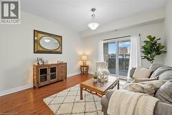 Living room with wood finished floors and baseboards -