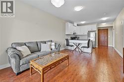 Living room with baseboards and wood finished floors -