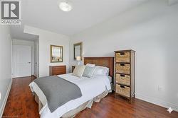 Bedroom featuring baseboards and dark wood-type flooring -