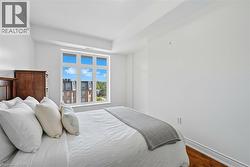 Bedroom with wood finished floors and baseboards -