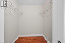 Spacious closet featuring dark wood finished floors -