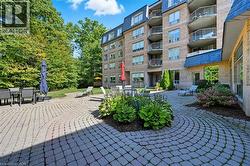 View of property's community featuring outdoor dining space and a patio area -