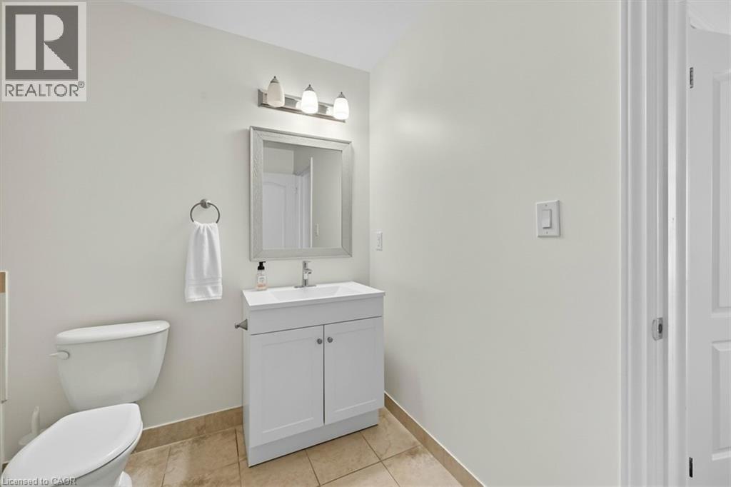 Half bath with vanity and light tile patterned floors - 8111 Forest Glen Drive Unit# 524, Niagara Falls, ON - Indoor Photo Showing Bathroom