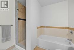 Full bath featuring a garden tub, a shower stall, and tile patterned flooring -