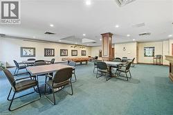 Dining space with pool table, recessed lighting, carpet floors, wooden walls, and decorative columns -