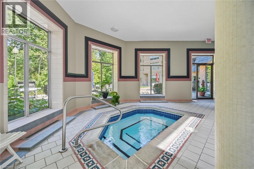View of pool with an in-ground hot tub - 8111 Forest Glen Drive Unit# 524, Niagara Falls, ON - Indoor Photo Showing Other Room With In Ground Pool