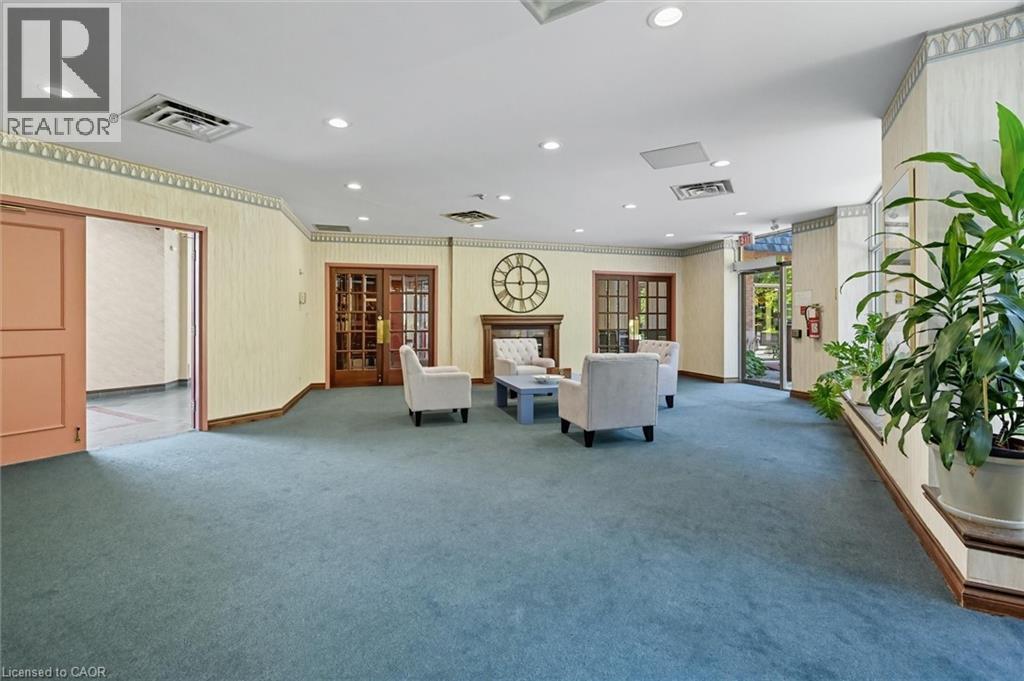 Living area featuring a premium fireplace, recessed lighting, ornamental molding, and french doors - 8111 Forest Glen Drive Unit# 524, Niagara Falls, ON - Indoor Photo Showing Other Room