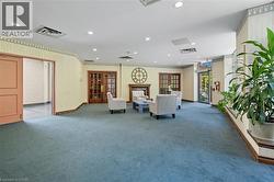 Living area featuring a premium fireplace, recessed lighting, ornamental molding, and french doors -