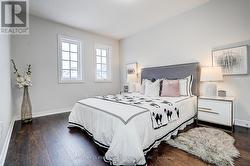 3nd bedroom with wood flooring, windows, closet -