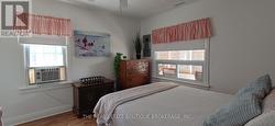 Dressers, a/c unit, ceiling fan and windows. -
