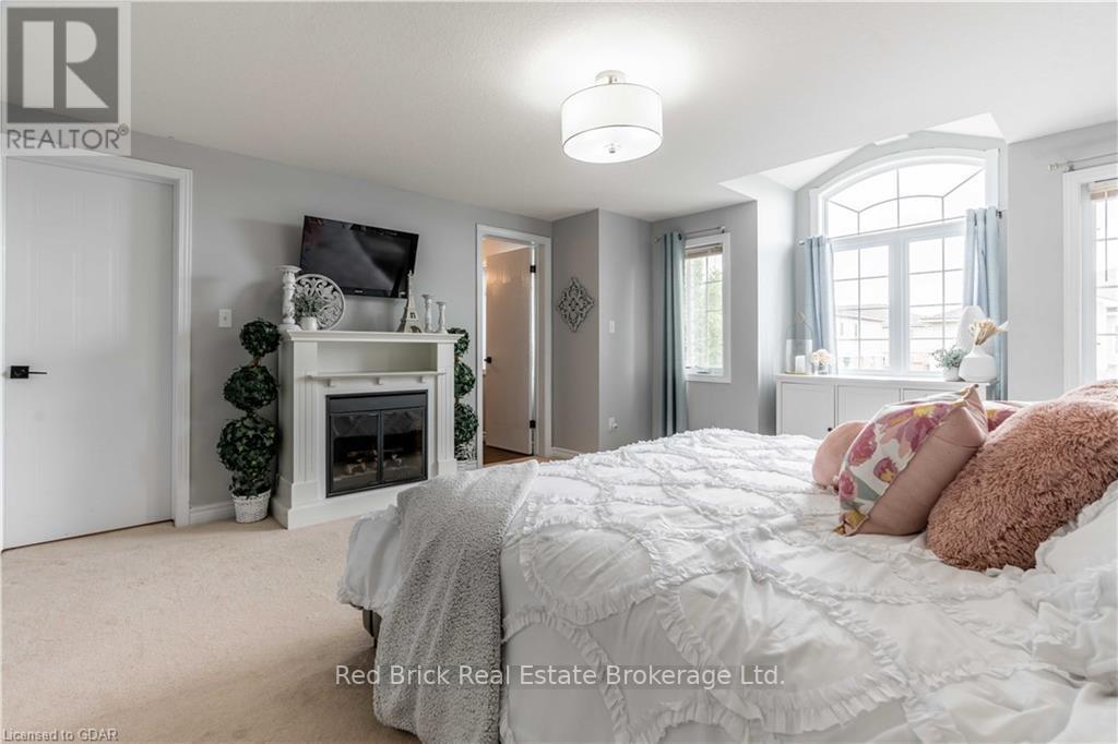24 - 20 Shackleton Drive, Guelph (Grange Road), ON - Indoor Photo Showing Bedroom With Fireplace