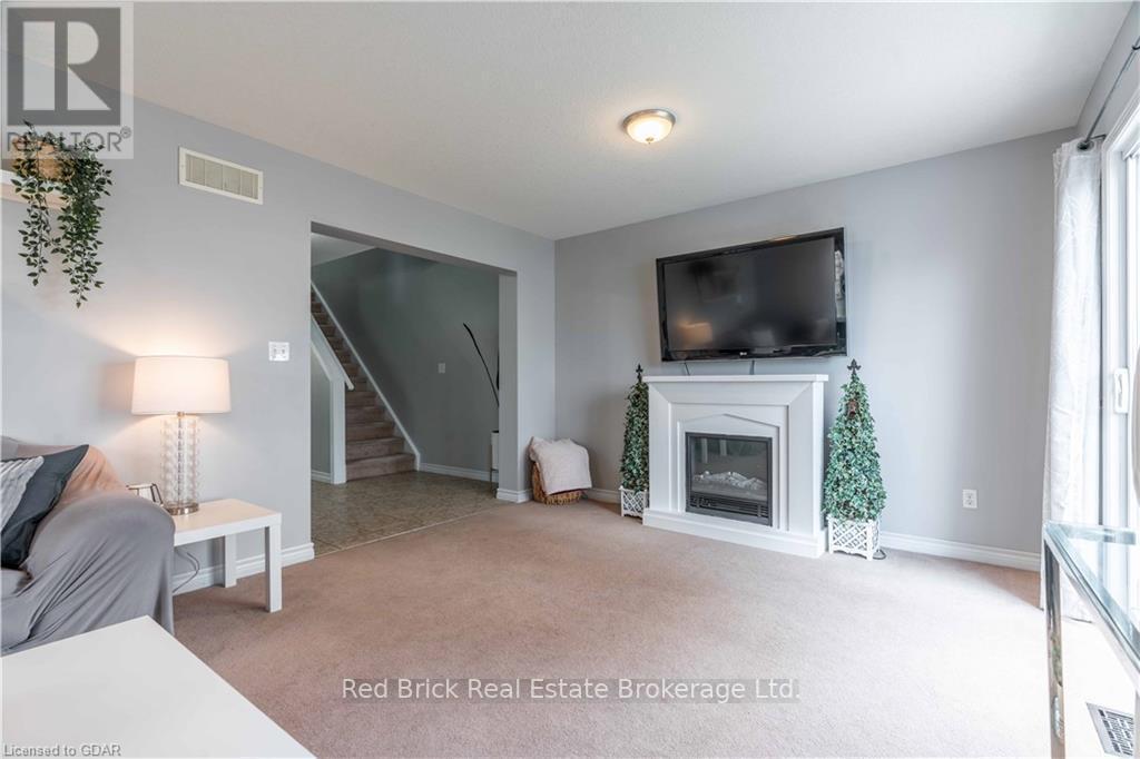 24 - 20 Shackleton Drive, Guelph (Grange Road), ON - Indoor Photo Showing Living Room With Fireplace