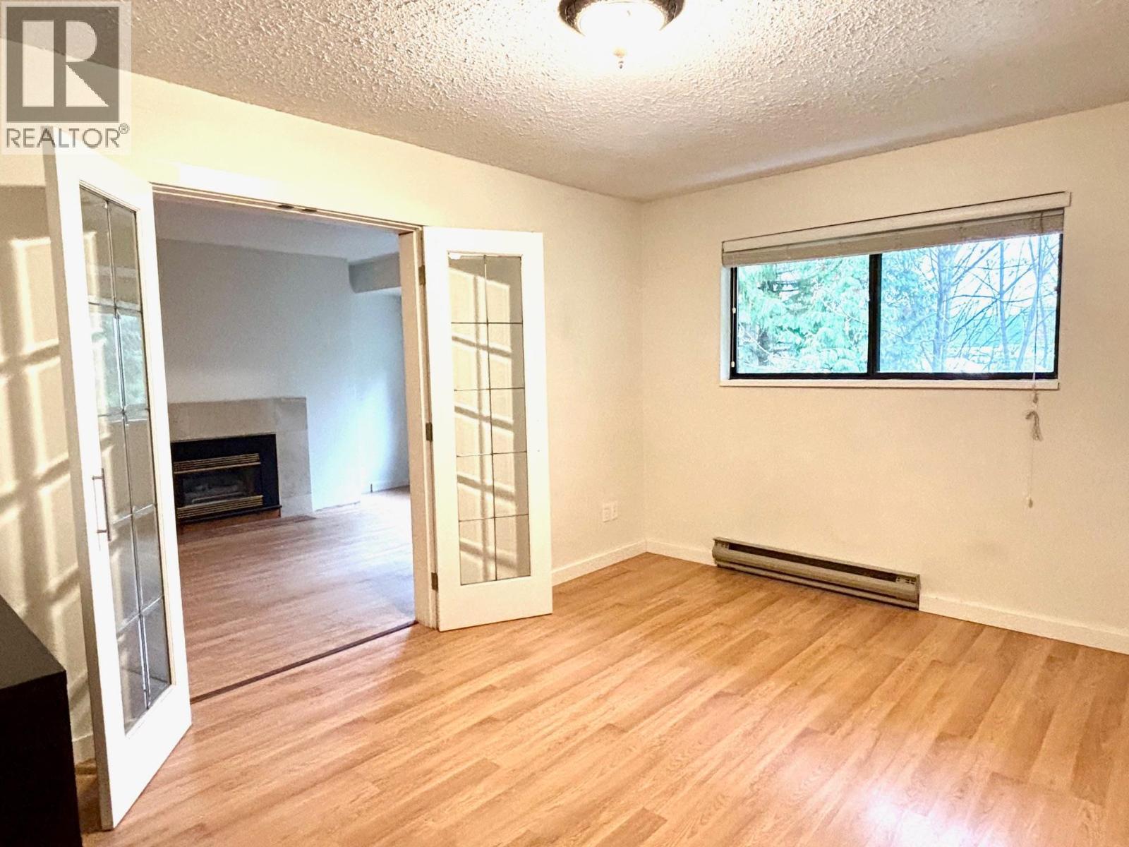 11 4832 Lazelle Avenue, Terrace, BC - Indoor Photo Showing Other Room With Fireplace