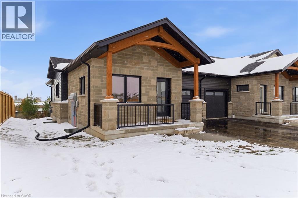 View of front of home with stone siding and covered porch - 29 Weymouth Street Unit# 25, Elmira, ON - Outdoor