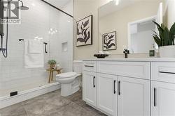 Bathroom featuring vanity, a shower stall, and light tile patterned floors -