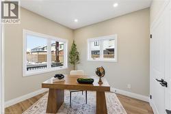 Office area featuring light wood-style floors and recessed lighting -