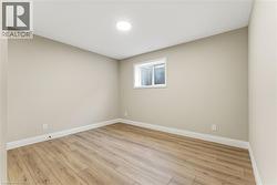 Empty room featuring baseboards and light wood-style flooring -