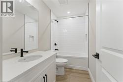 Full bath featuring light wood finished floors, vanity, shower / bathtub combination, and recessed lighting -