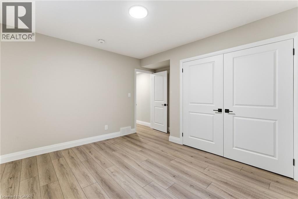 Unfurnished bedroom with light wood-style flooring and a closet - 29 Weymouth Street Unit# 17, Elmira, ON - Indoor Photo Showing Other Room