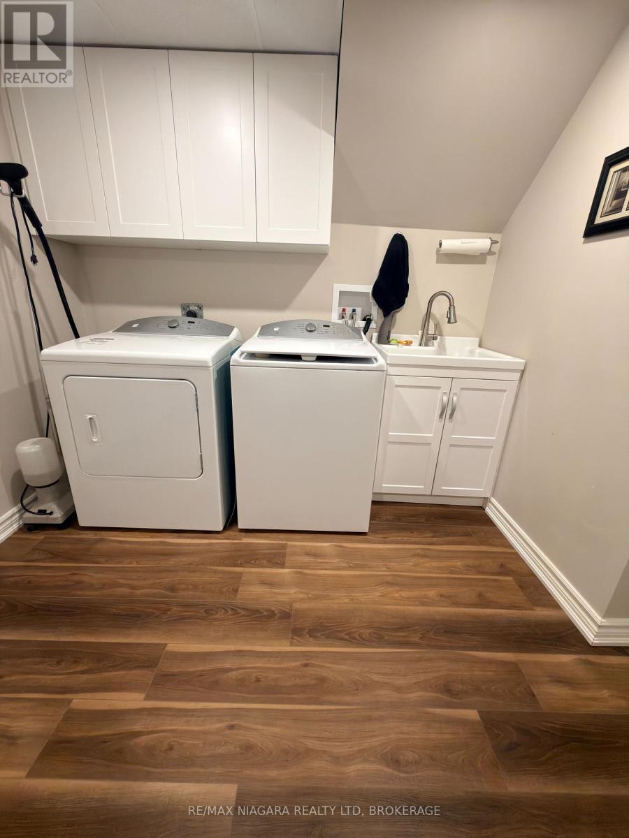 Laundry with Upgraded LVP flooring - 21 - 141 Welland Vale Road, St. Catharines (Grapeview), ON - Indoor Photo Showing Laundry Room