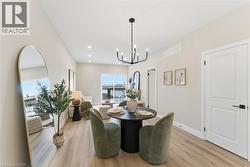 Dining area with light wood finished floors, recessed lighting, and a chandelier -