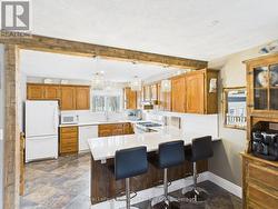 Kitchen w/ quartz countertops, natural gas stove -