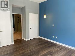 Empty room featuring dark wood finished floors and baseboards -