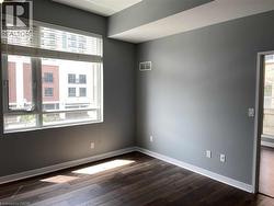 Unfurnished room featuring dark wood-style flooring -