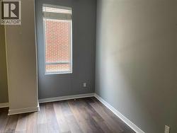 Unfurnished room with baseboards and dark wood finished floors -
