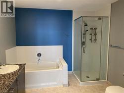 Bathroom with vanity, a bath, a shower stall, and light tile patterned floors -