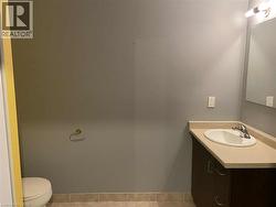 Half bath with vanity and light tile patterned floors -