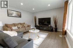 Living area with recessed lighting and wood finished floors -