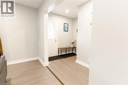 Foyer with light wood-style floors and recessed lighting -