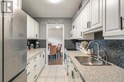 Kitchen with lovely countertops/ backsplash -