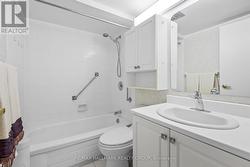 Clean and bright bathroom with full tub & storage. -