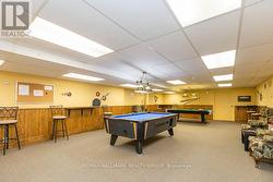 Games room with pool table and lounge seating -