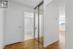 Bright entryway with mirrored closets for storage. -