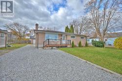 Front of house, driveway leading to 2-car garage -