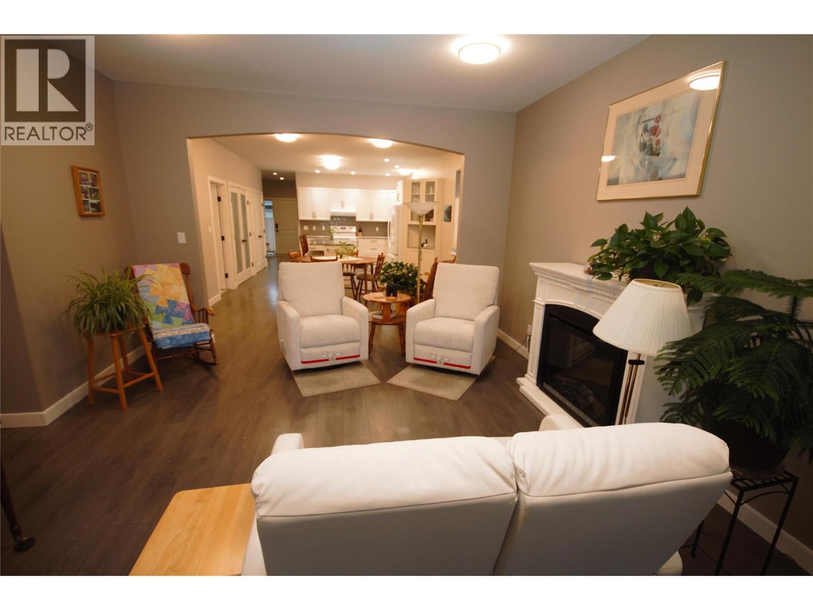 Living Room - 131 Willows Place, Oliver, BC - Indoor Photo Showing Living Room With Fireplace