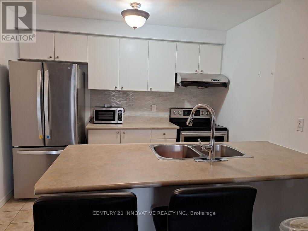 304 - 91 Aspen Springs Drive, Clarington, ON - Indoor Photo Showing Kitchen With Stainless Steel Kitchen With Double Sink With Upgraded Kitchen