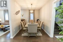 Dining area with dark wood finished floors and baseboards -