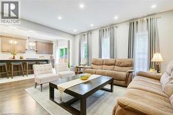 Living room with recessed lighting and light wood finished floors -