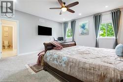 Carpeted bedroom featuring recessed lighting and a ceiling fan -
