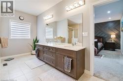 Full bathroom featuring double vanity, connected bathroom, light tile patterned floors, a stall shower, and light carpet -