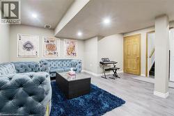 Living room featuring light wood-style flooring, recessed lighting, and stairway -